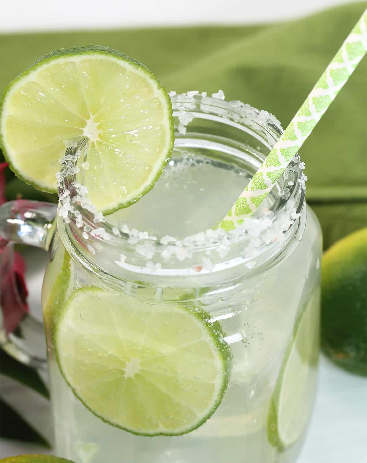 Closeup of Ranch Water cocktail with sliced limes in it.