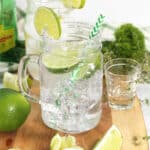 Cocktail with straw and garnished with lime.