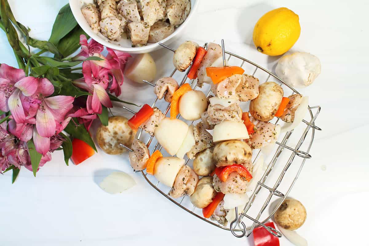 Chicken Kabobs placed on skewer rack.