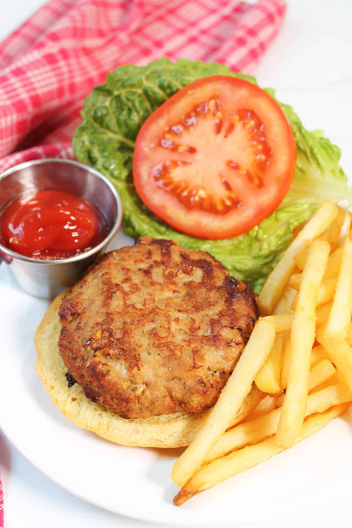 Air Fryer Turkey Burger on open bun with french fries.