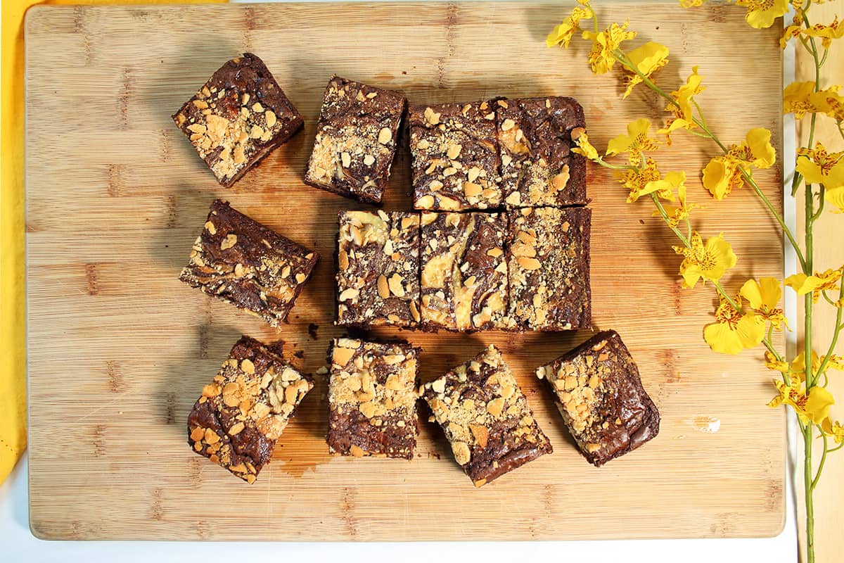 Sliced banana pudding brownies on wooden cutting board.