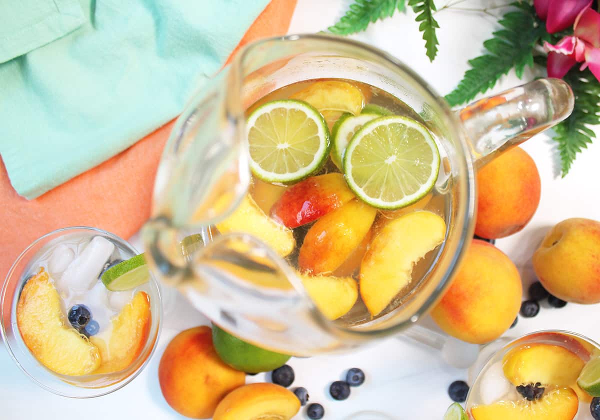 Looking down into pitcher of white peach sangria.