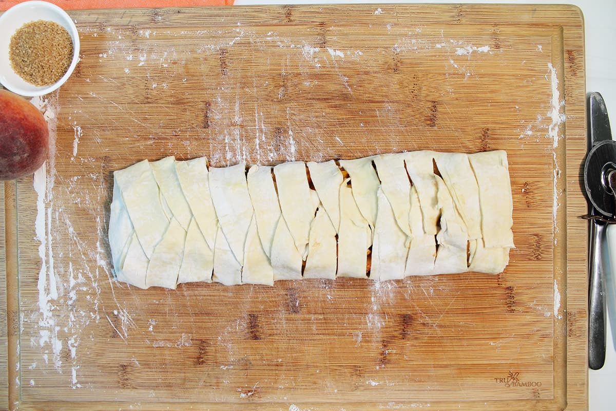 Braided pastry on wooden board.