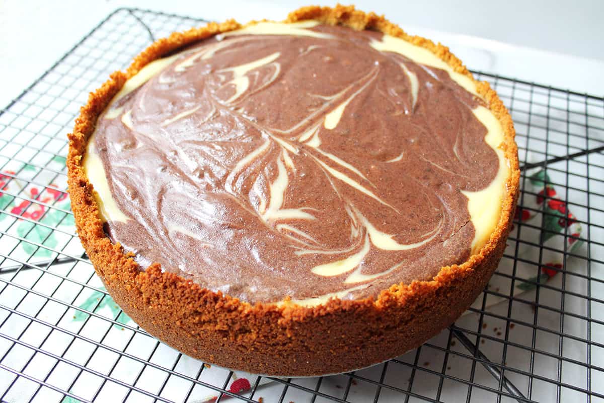 Closeup of whole chocolate and vanilla cheesecake showing marble effect.