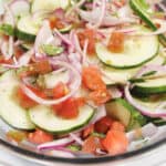 Closeup of cucumber tomato onion salad.