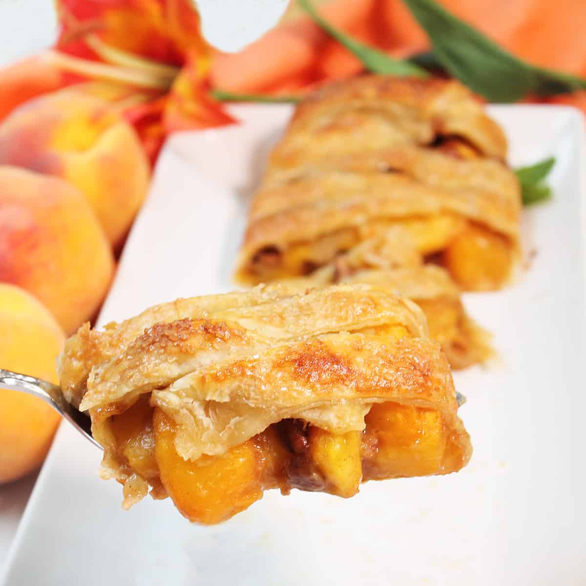 Lifting slice of Peach Strudel from platter.