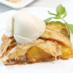 Peach strudel with ice cream on top.