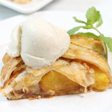 Peach strudel with ice cream on top.