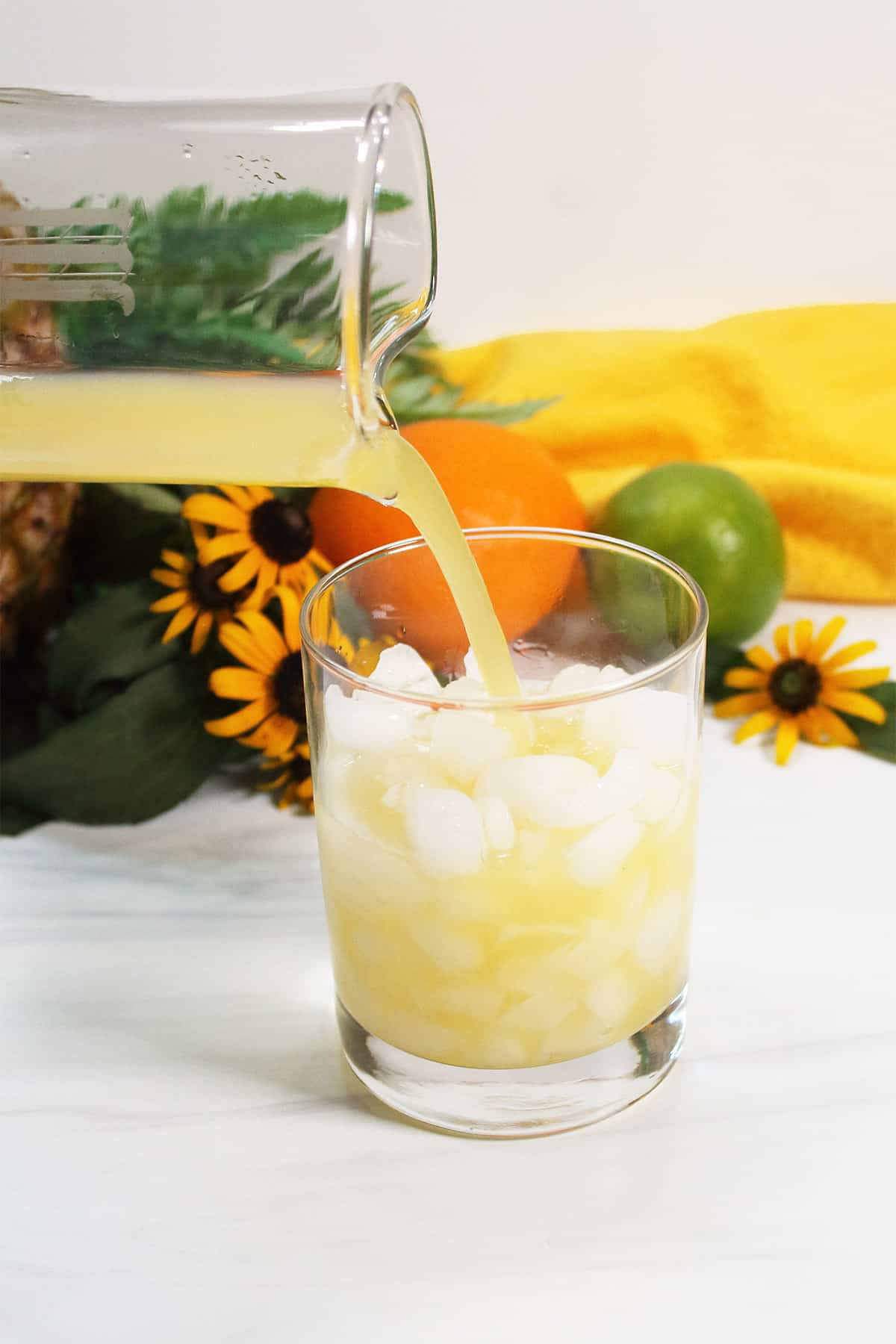 Pouring mixed drink over ice.
