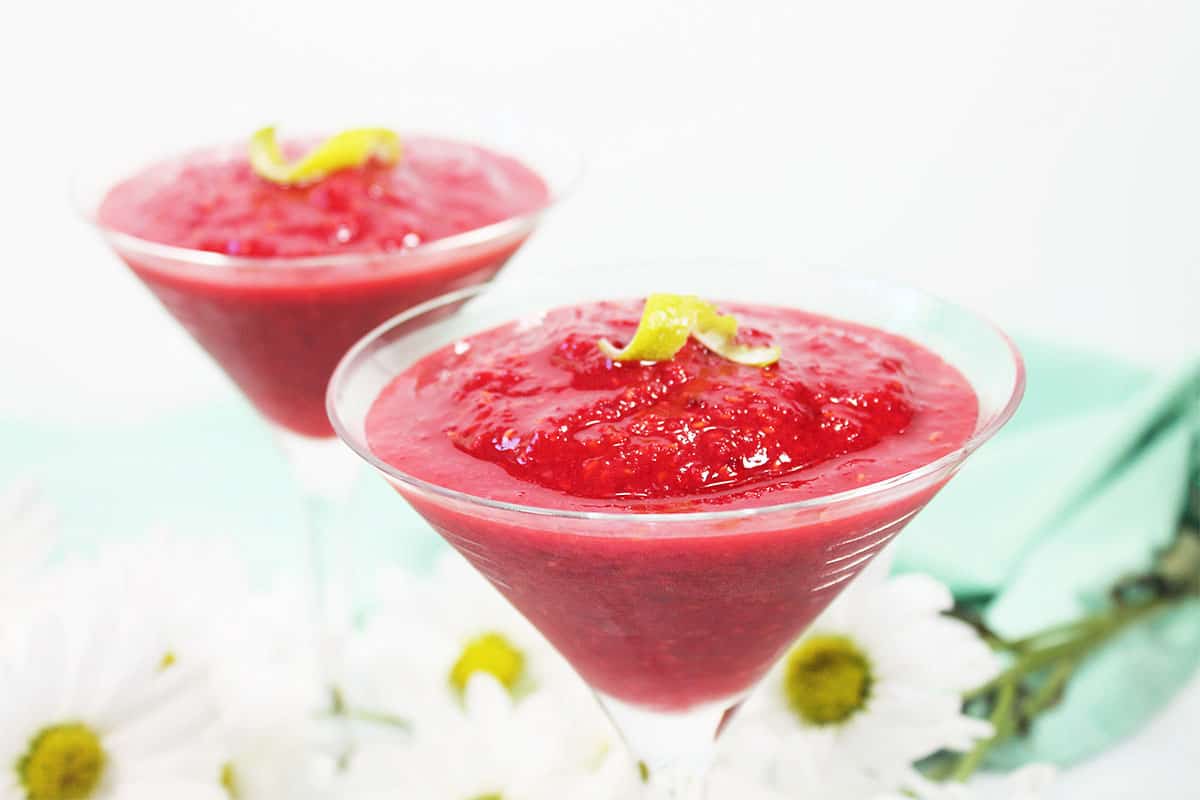Garnishing cocktail with lime twist.
