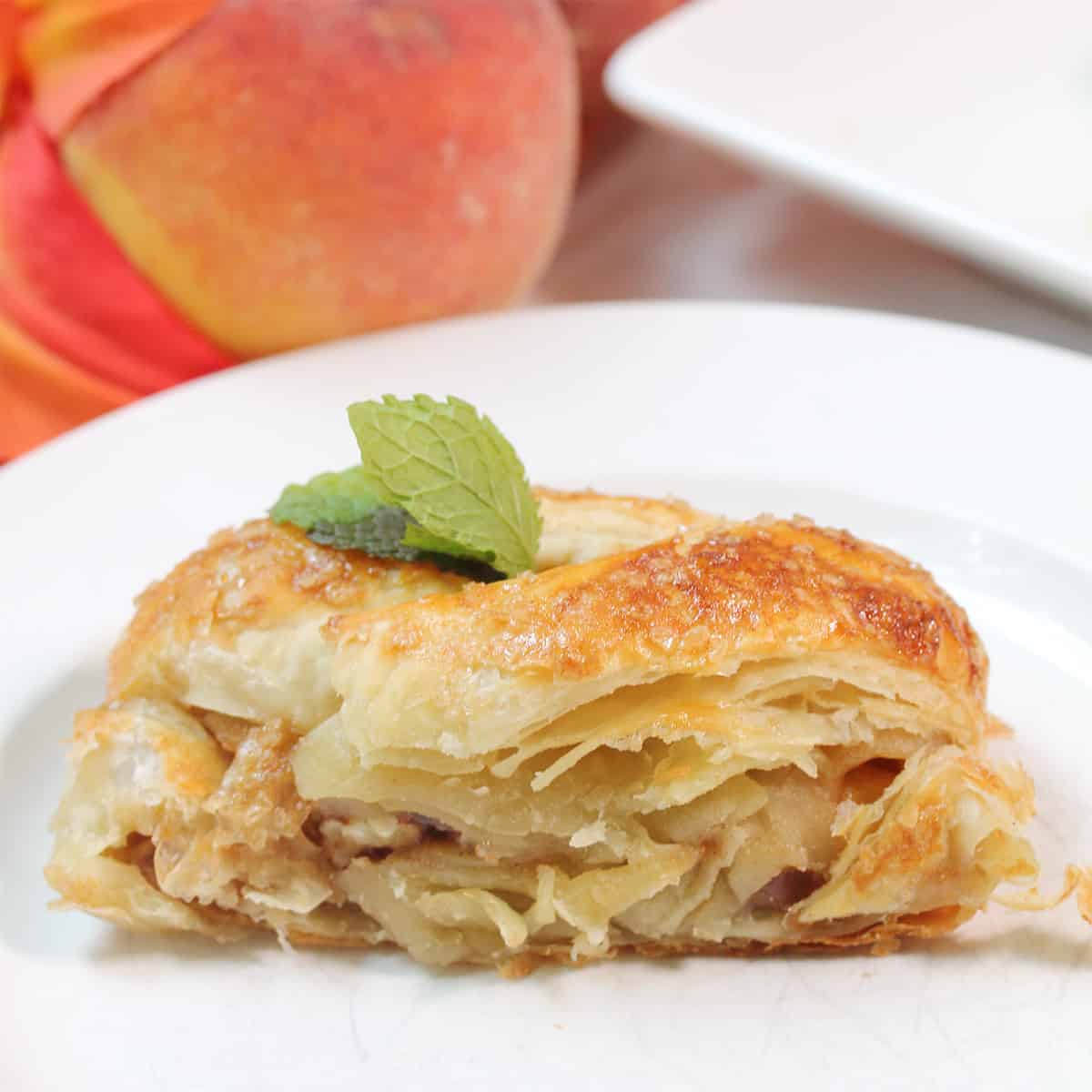 Slice on plate in front of peaches.