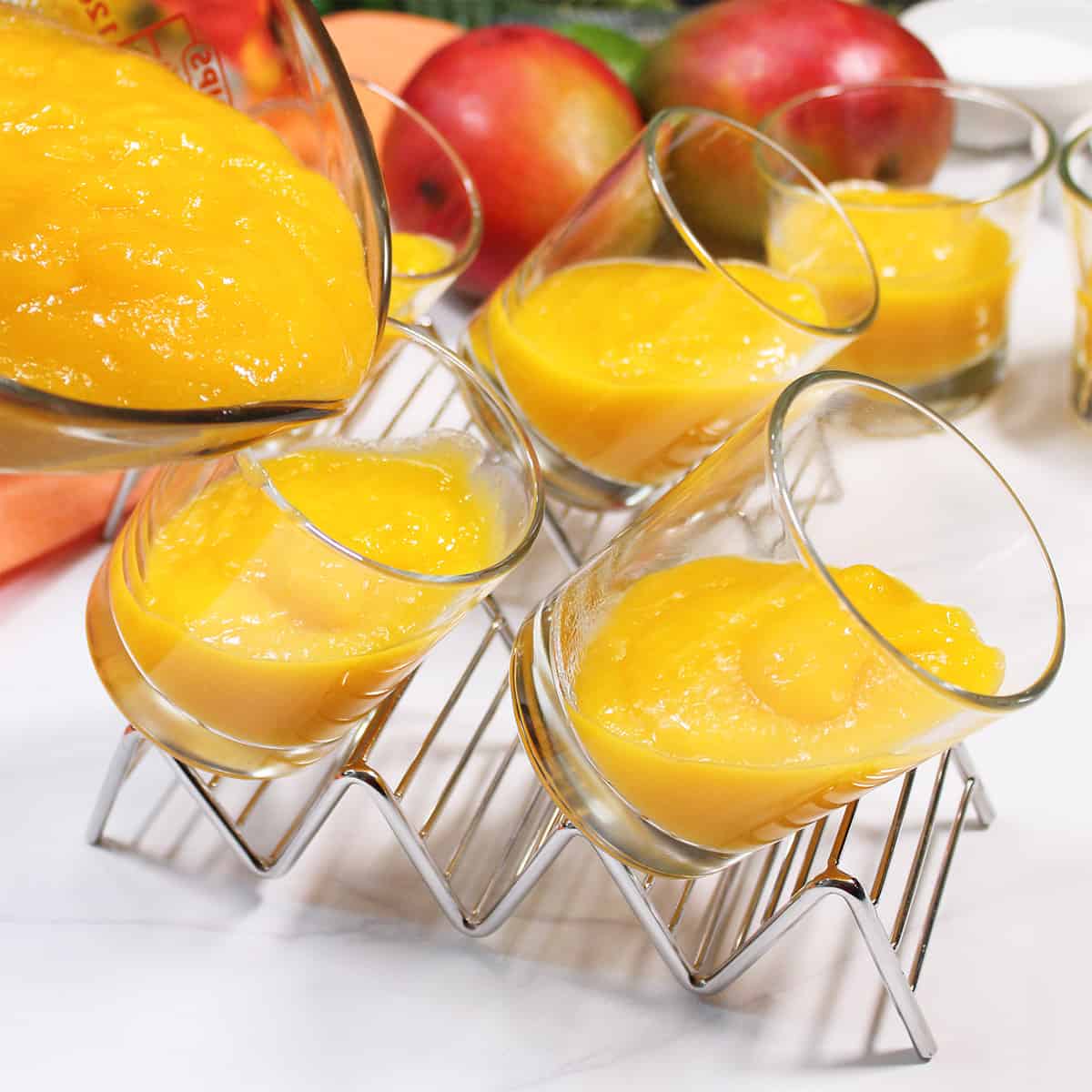 Step seven, pouring mango mixture into angled glass dishes.