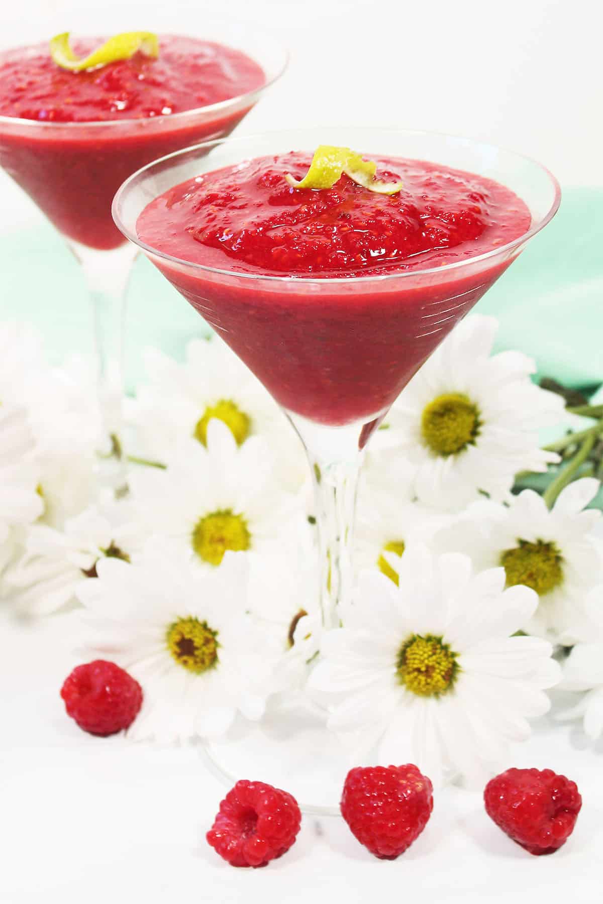 Two Raspberry Daiquiris among flowers.