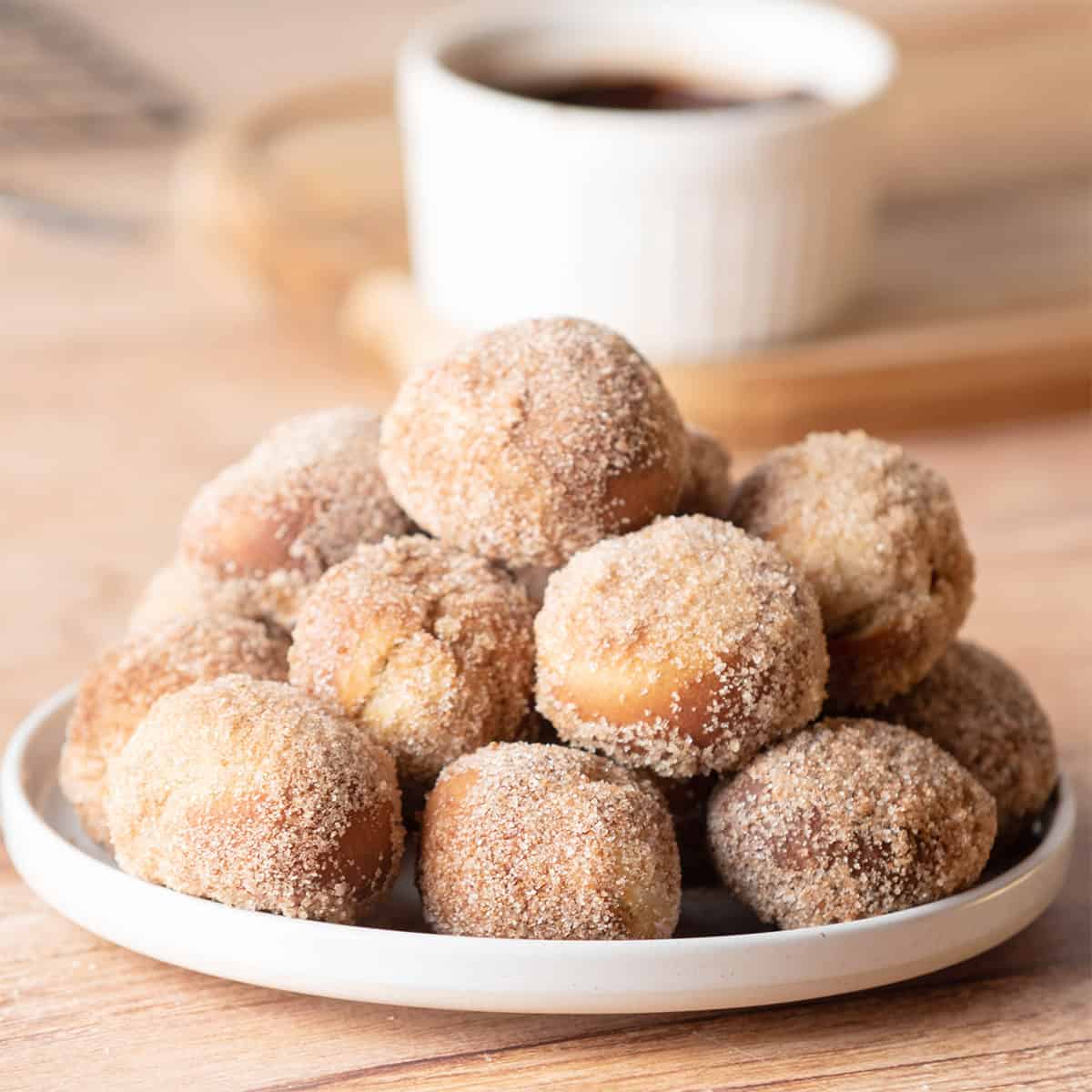 Air Fryer Donut Holes stacked on plate.