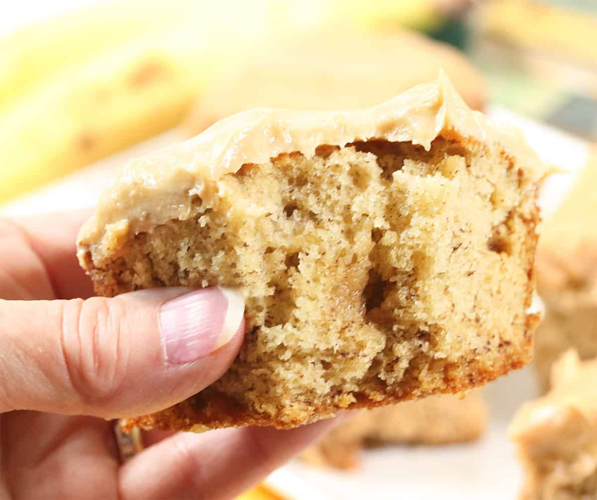 Holding cake with bite out of it.