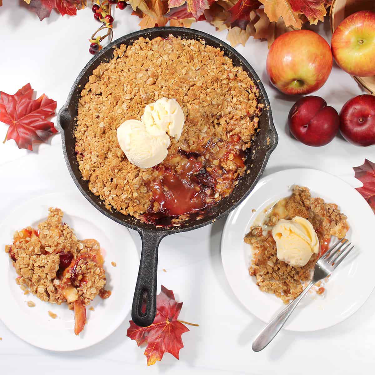 Overhead of crumble in skillet with servings on side.