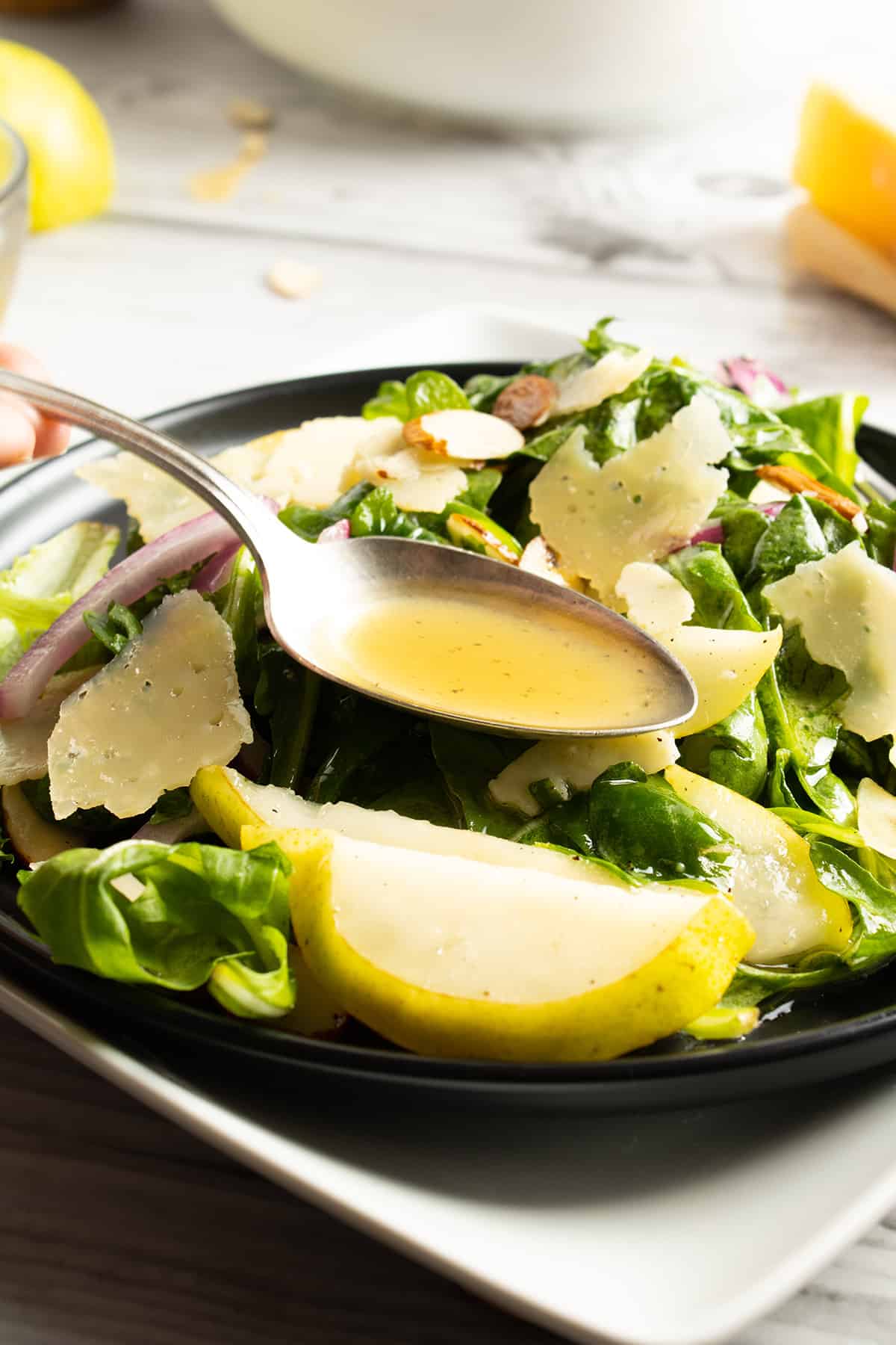 Drizzling vinaigrette on salad.