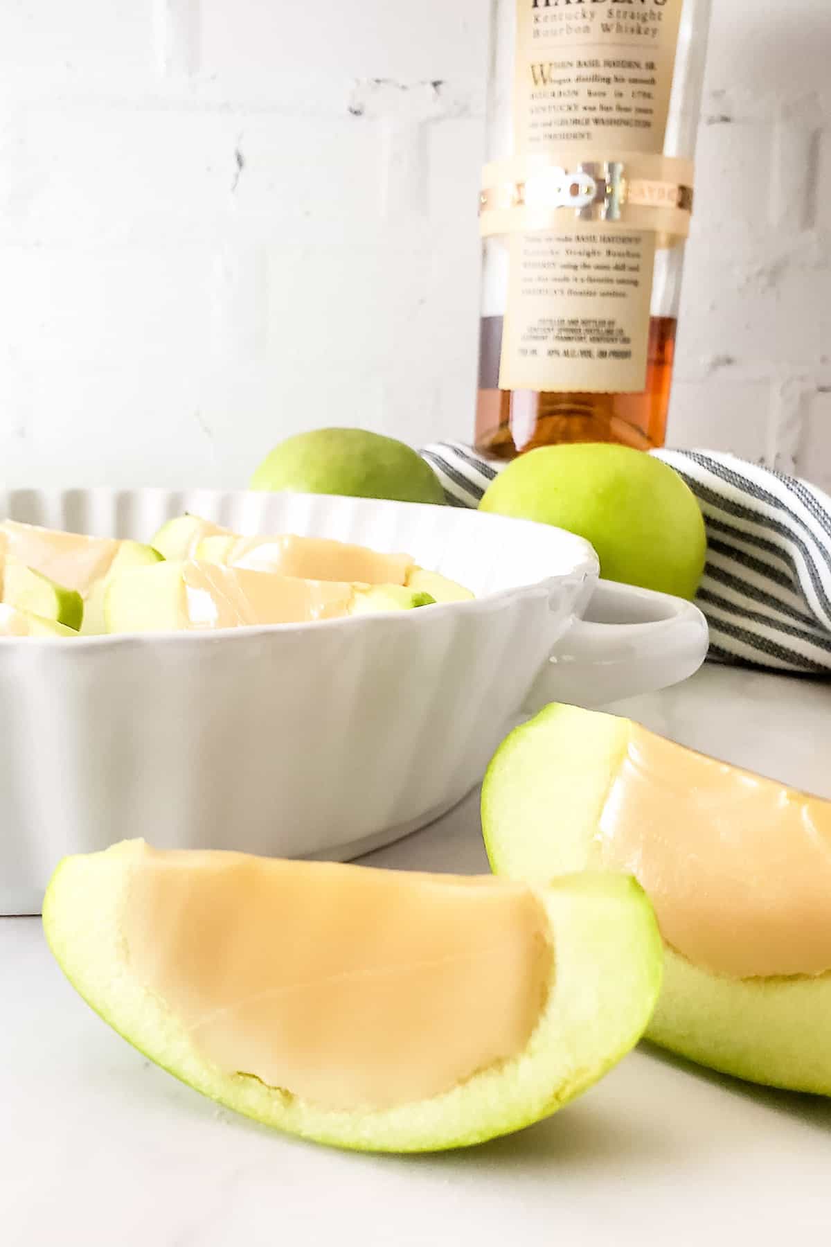 Two Caramel Apple Shots in front of dish.