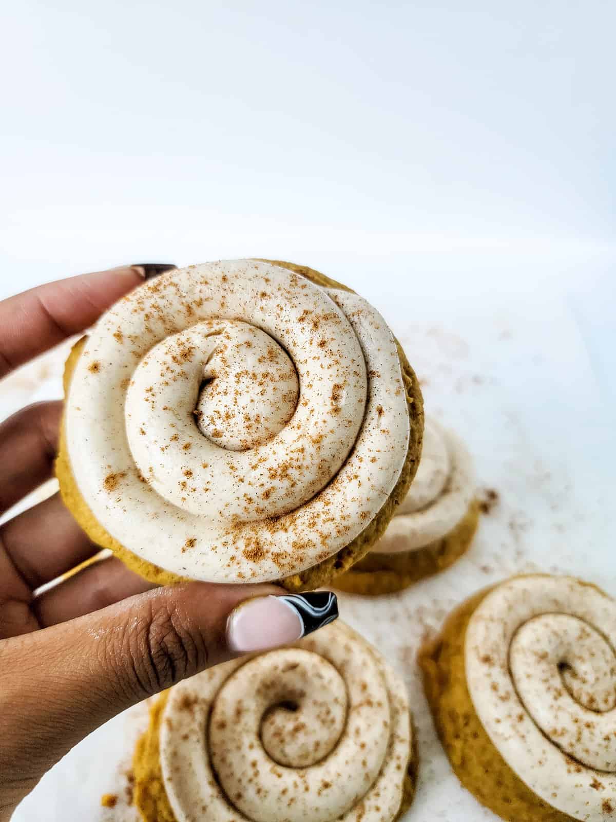Holding cookie showing Crumbl swirl.