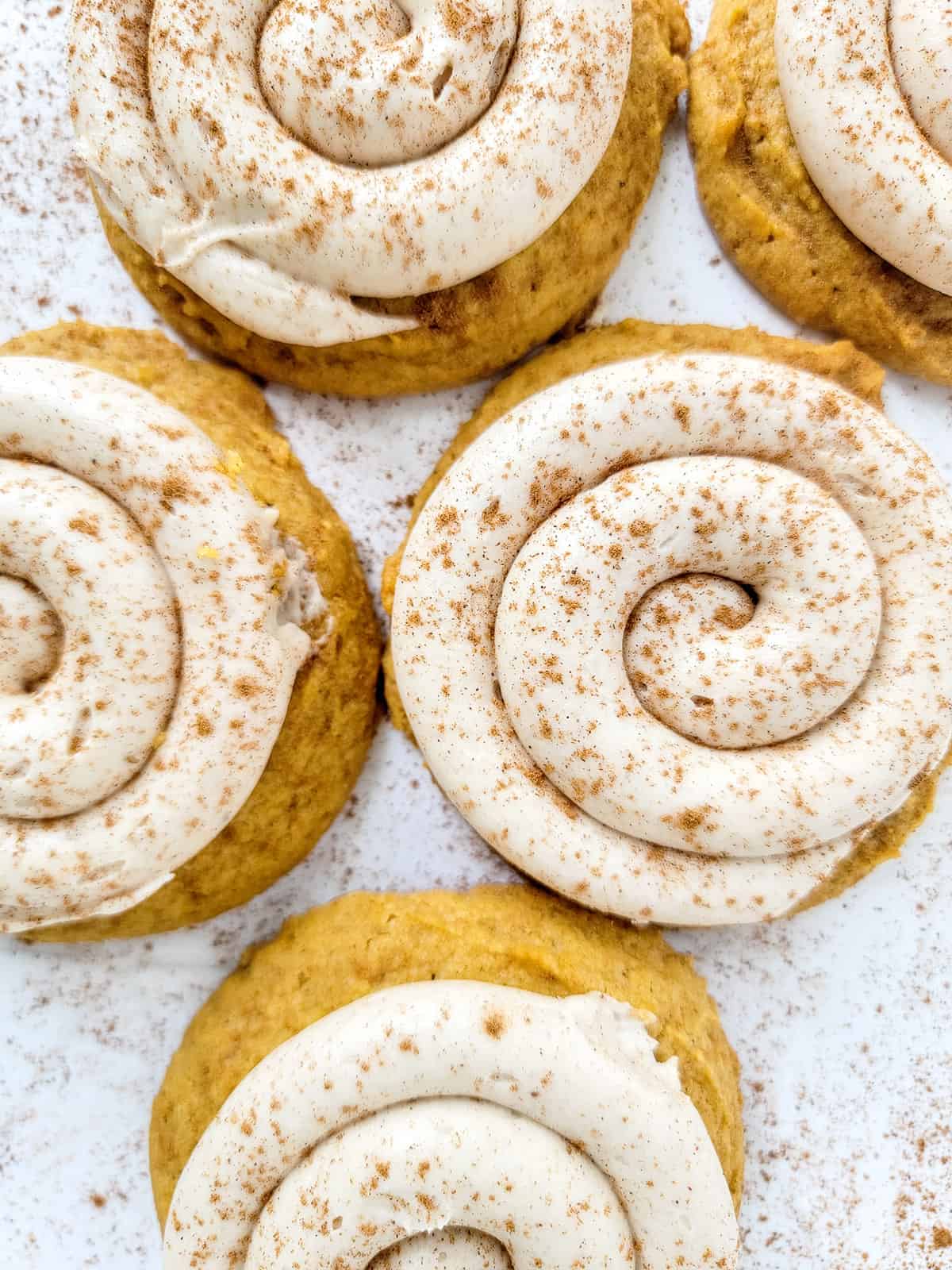 Overhead of swirled frosting on Crumbl Pumpkin Pie Cookies.