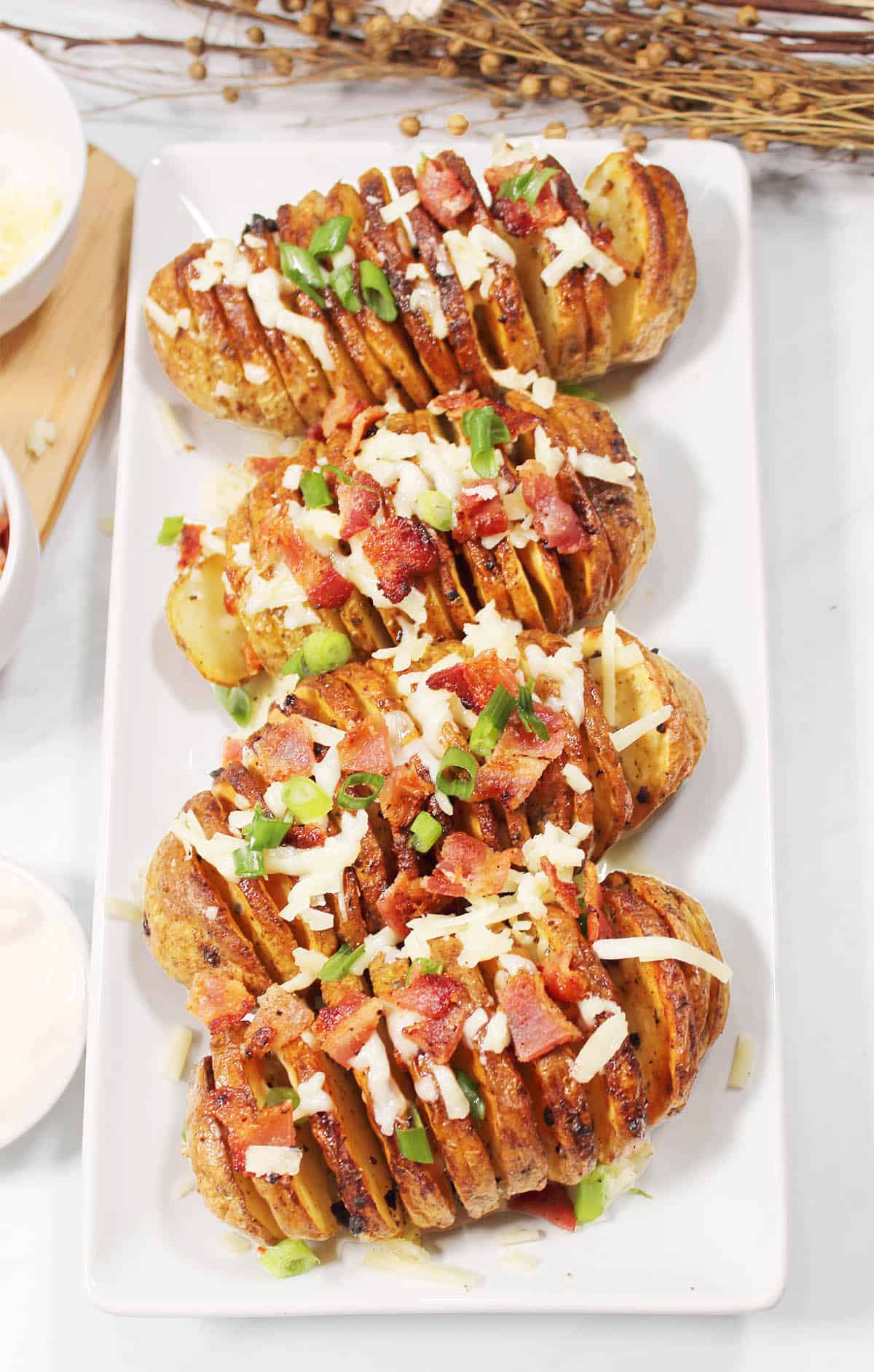 Serving platter of air fried hasselback potatoes.