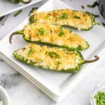 Three air fried jalapeno poppers on plate.