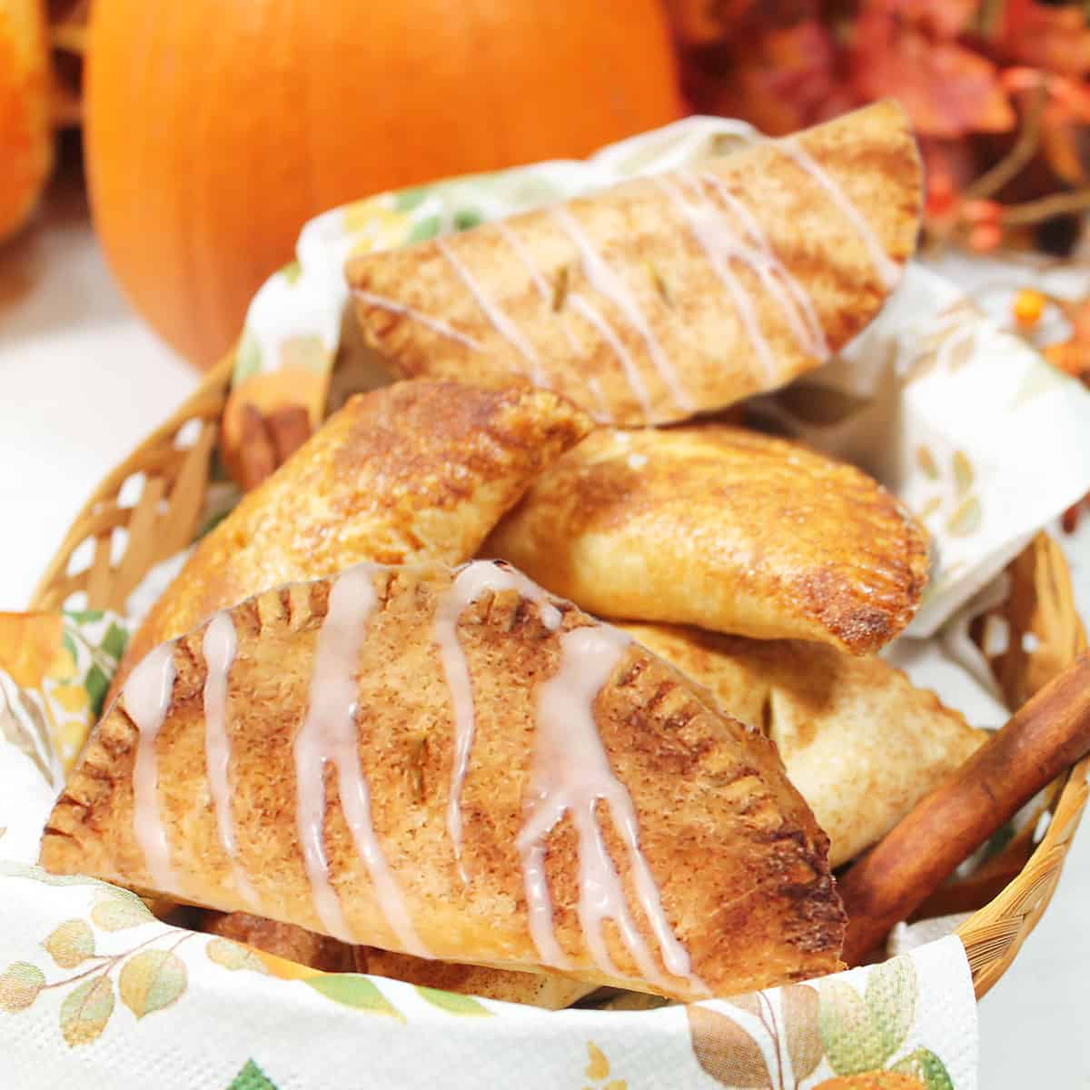 Cinnamon sugar and glazed easy hand pies in basket.