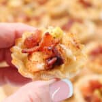 Holding phyllo cup appetizer.