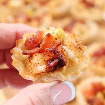 Holding phyllo cup appetizer.