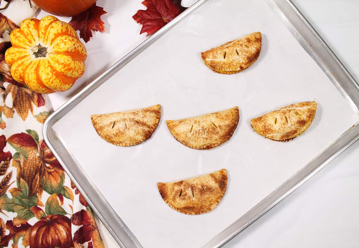 Oven baked hand pies on coolie sheet.