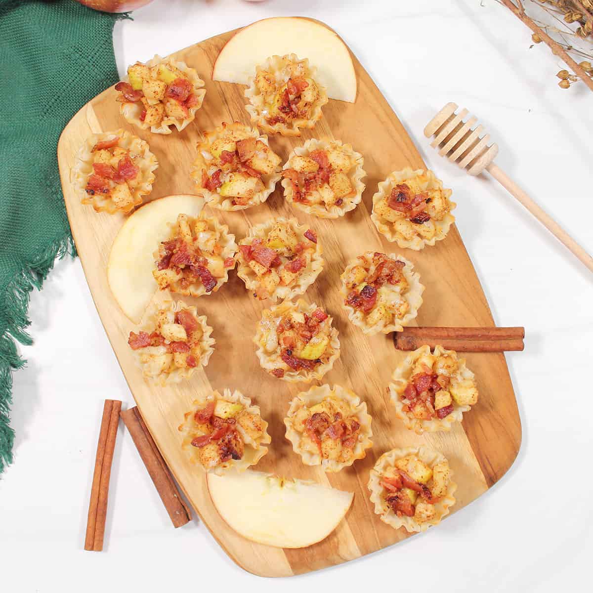 Overhead of phyllo cup appetizers on wooden board.