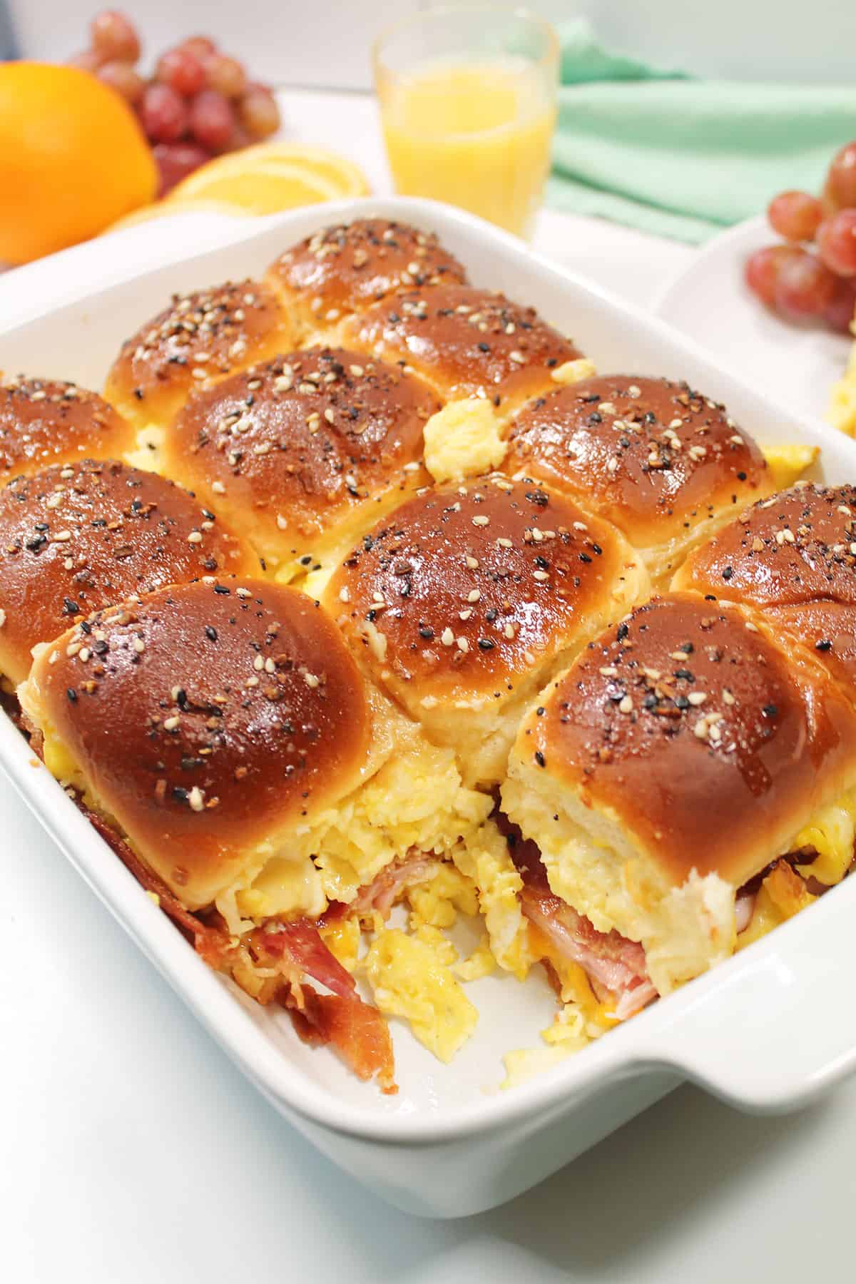 Baking dish with one Hawaiian roll breakfast slider removed.