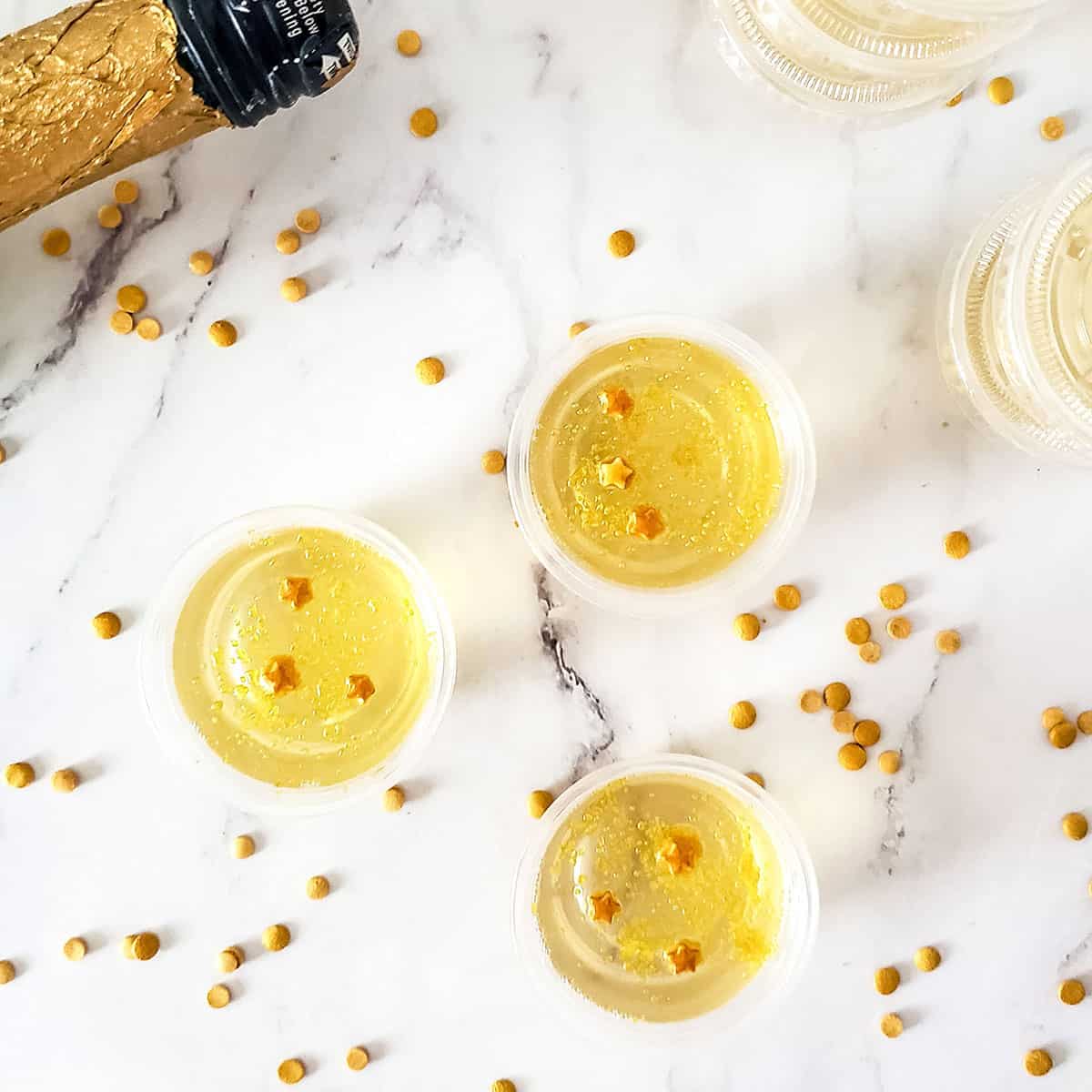 Overhead of jello shots with scattered sprinkles.