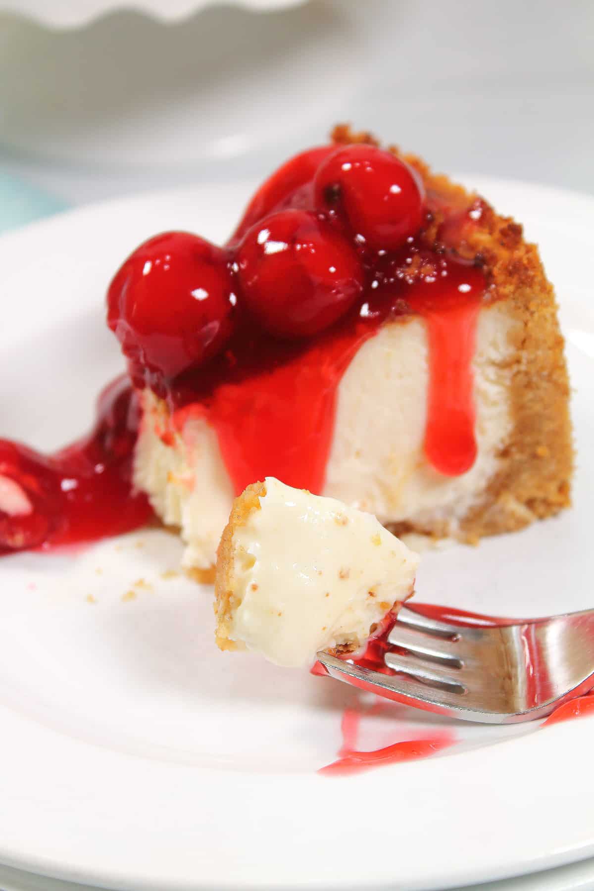 Closeup of bite of cheesecake on fork.