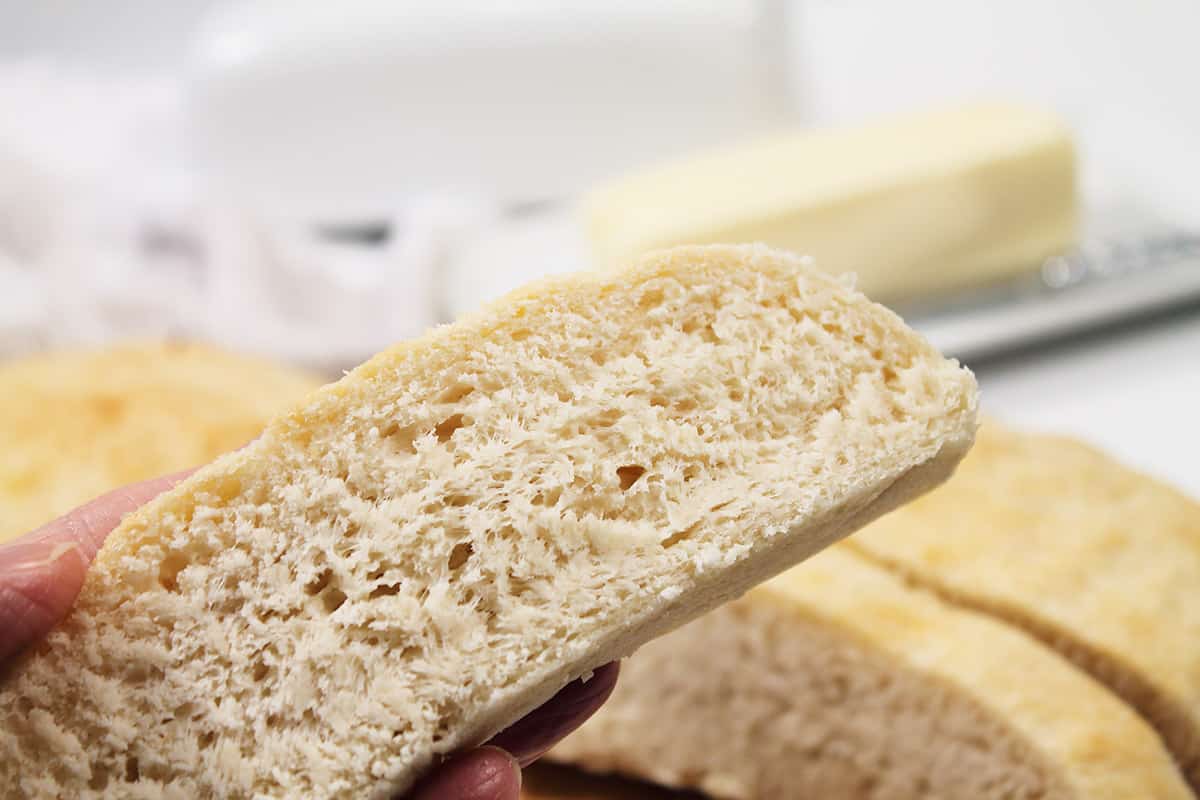 Holding slice of bread.