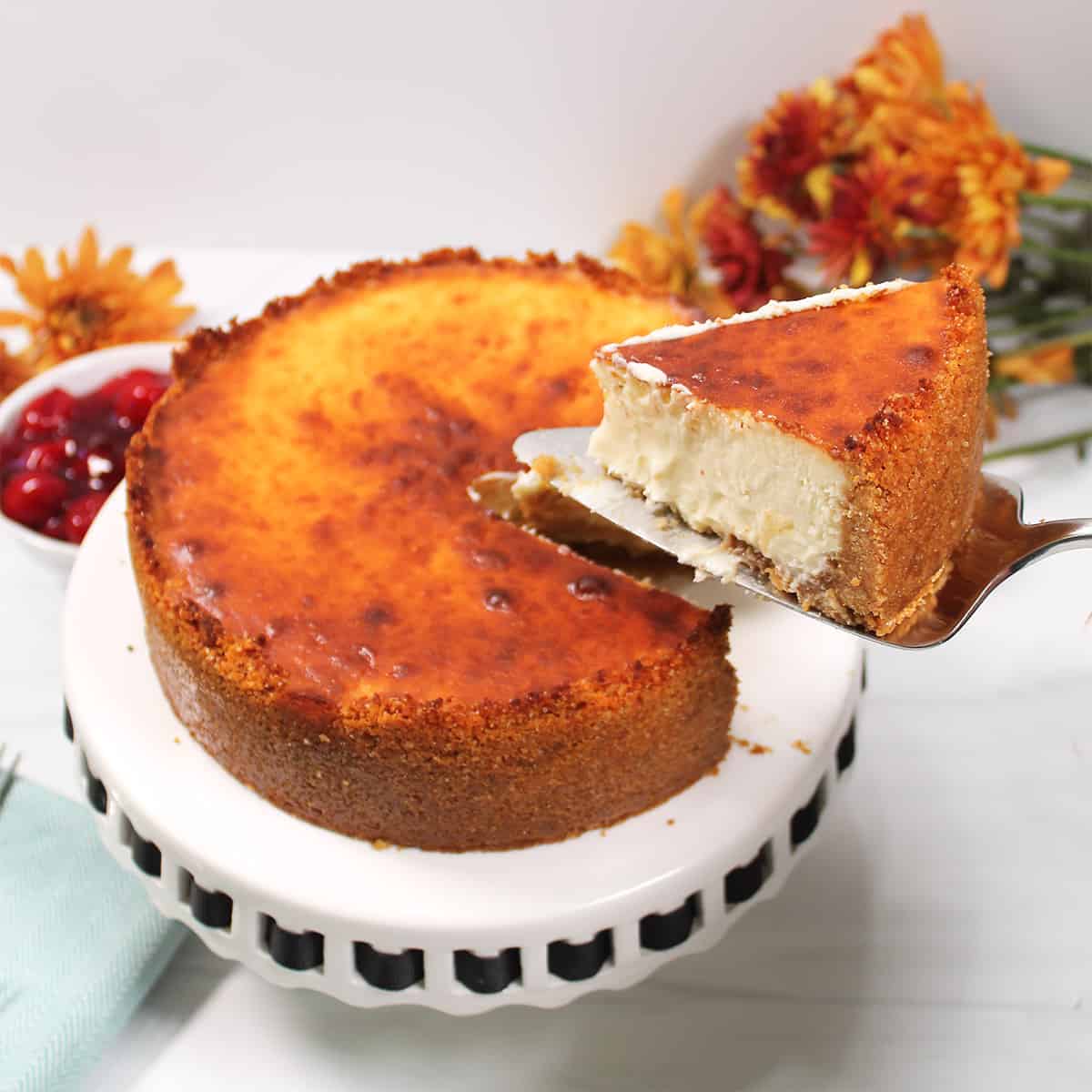 Lifting slice of air fryer cheesecake.