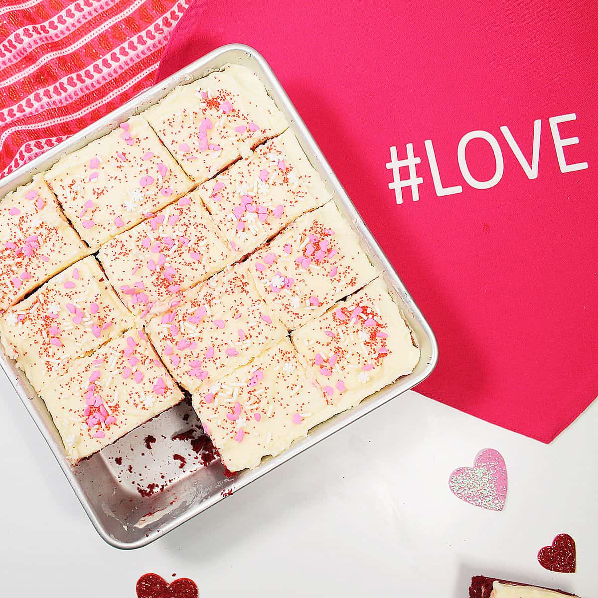 Overhead of cut brownies in pan with love placemat.