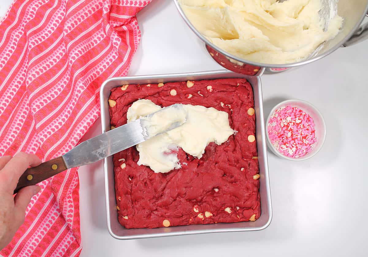Spreading frosting on brownies.