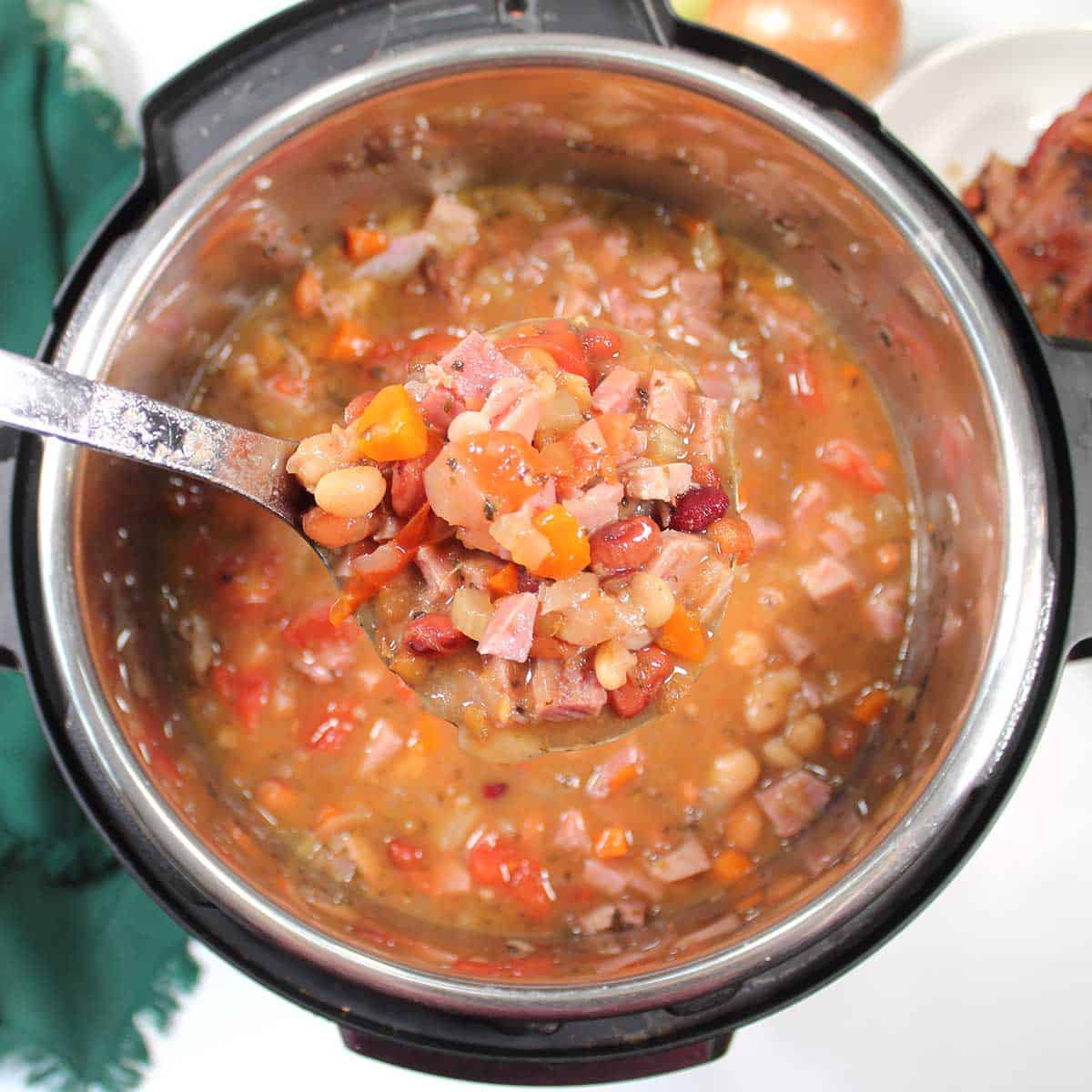 Ladle of finished soup over instant pot.