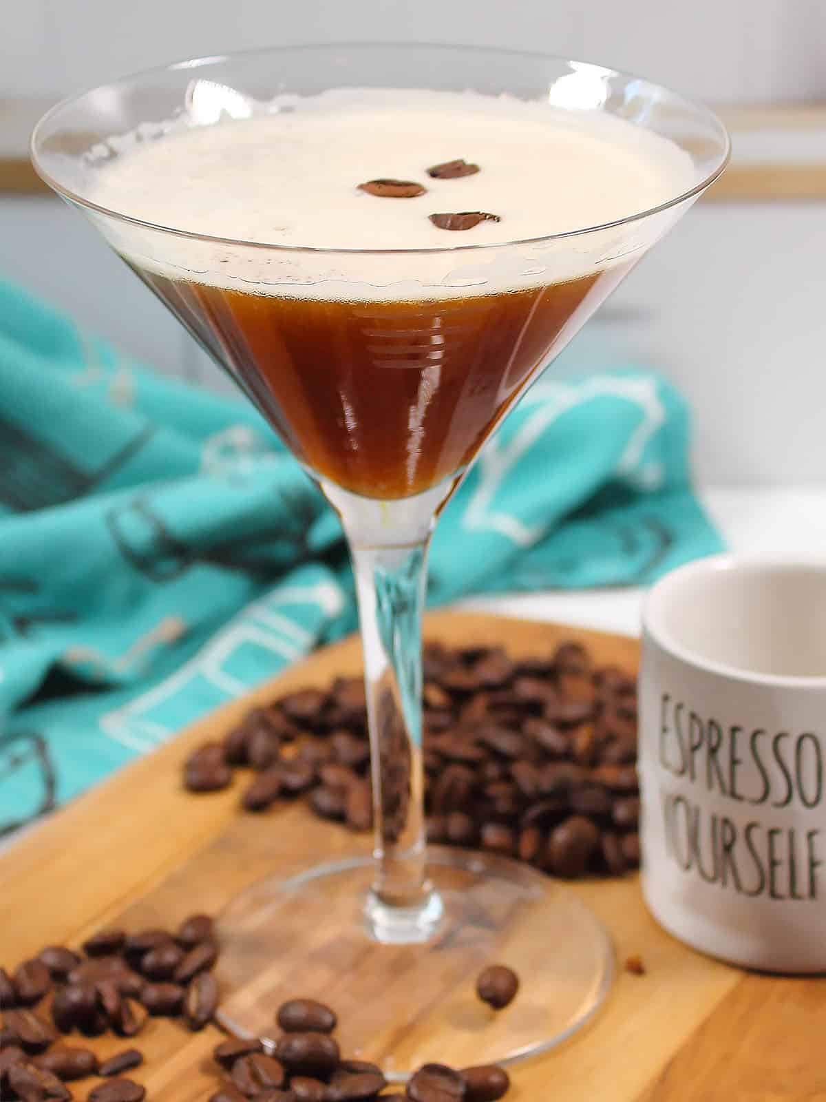 Single espresso martini on wooden board.