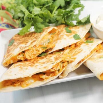 Closeup of cooked quesadilla showing buffalo chicken filling.