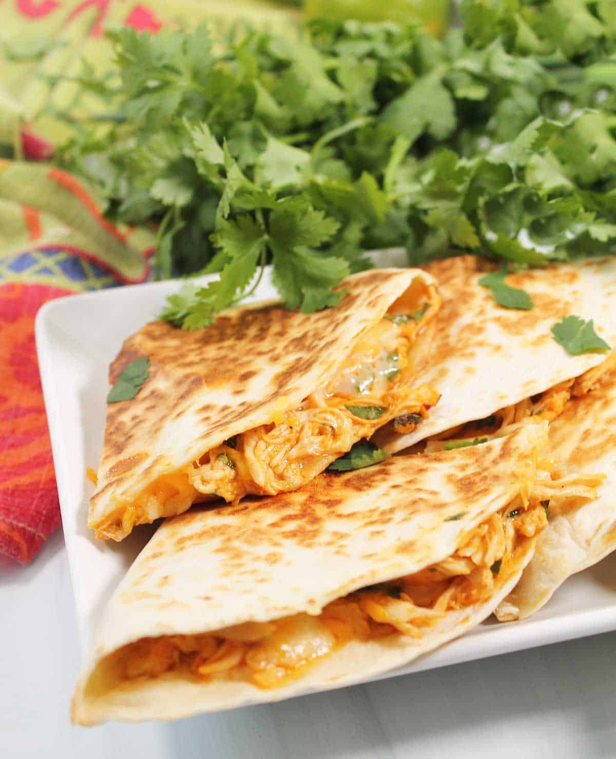 Showing buffalo chicken filling inside quesadillas.
