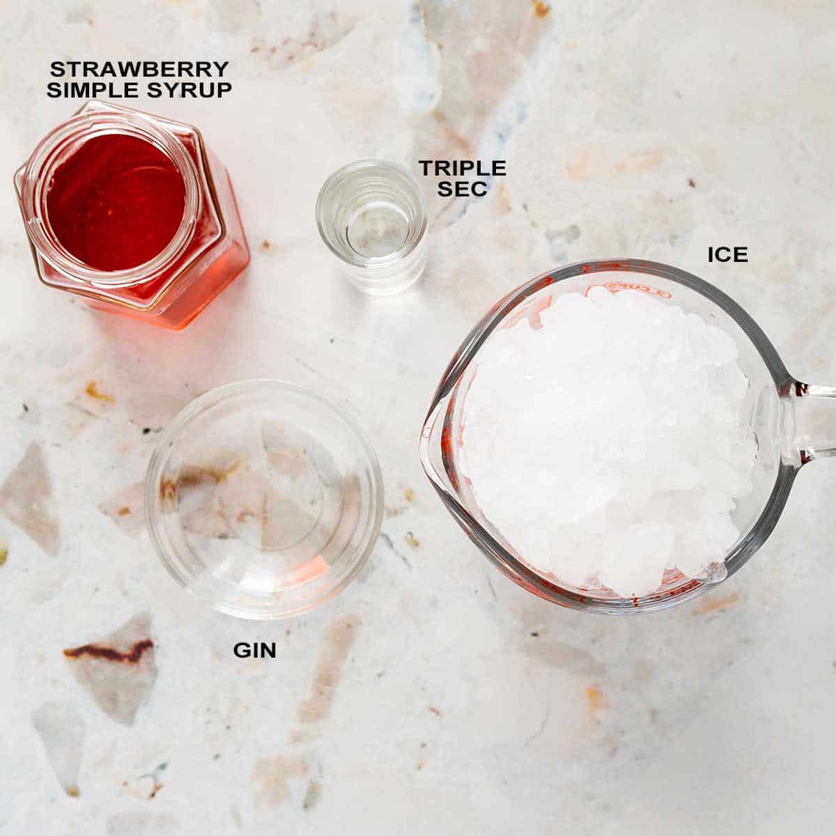 Ingredients to make a strawberry martini drink.