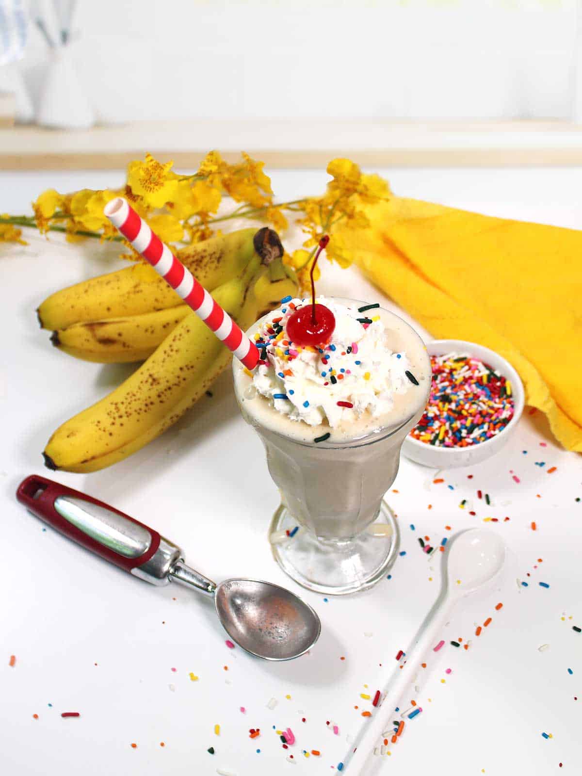 Overhead of milkshake with bananas and sprinkles.