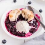 Closeup of serving in bowl with scoop of ice cream.
