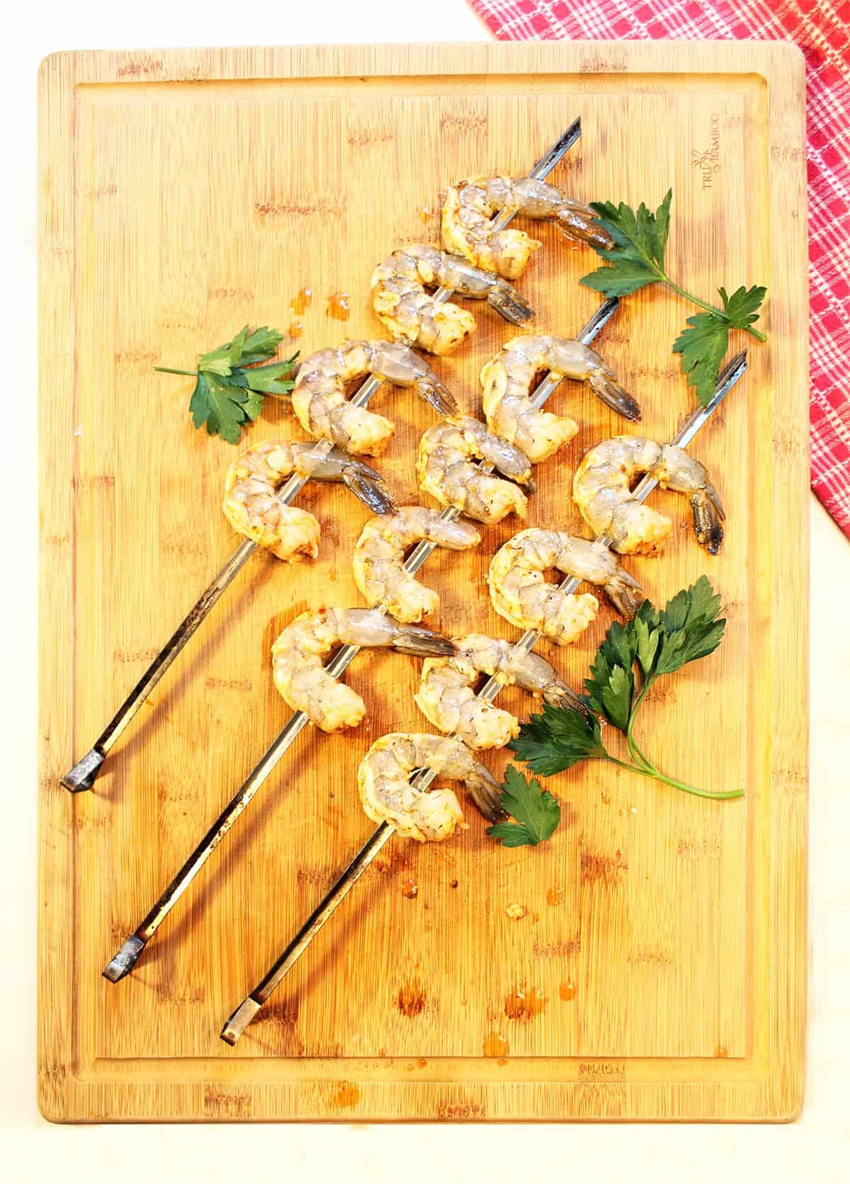 Marinated shrimp on skewers ready to grill.