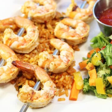 Spicy Grilled Shrimp plated over rice.