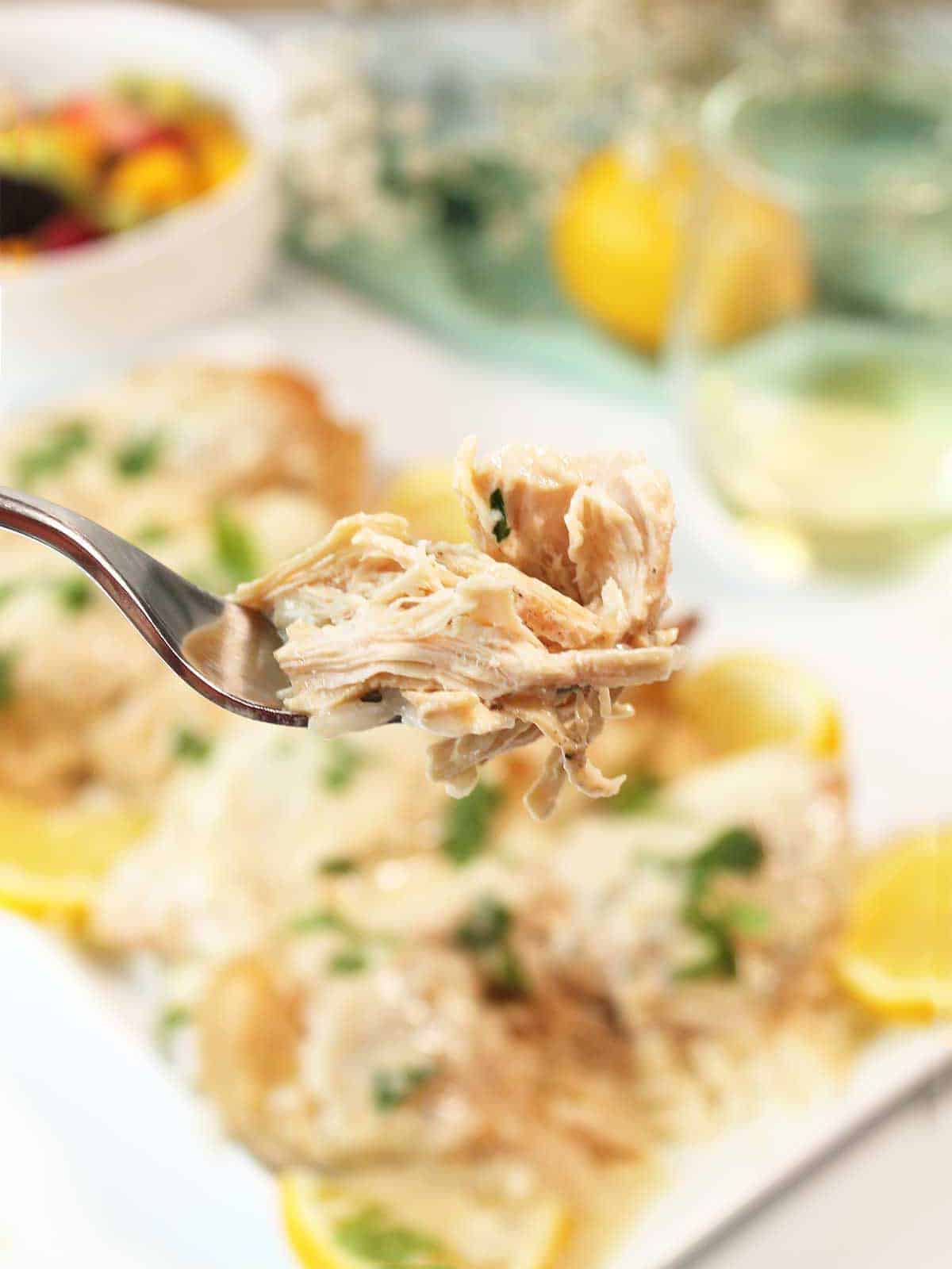 Bite of lemon pepper chicken on fork.