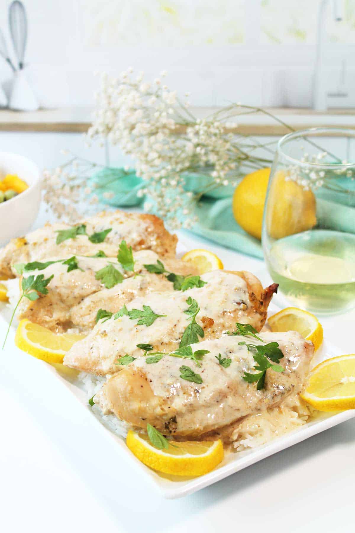 Crockpot Lemon Pepper Chicken on serving platter on counter.