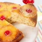 Lifting slice of cake from whole upside down cake.